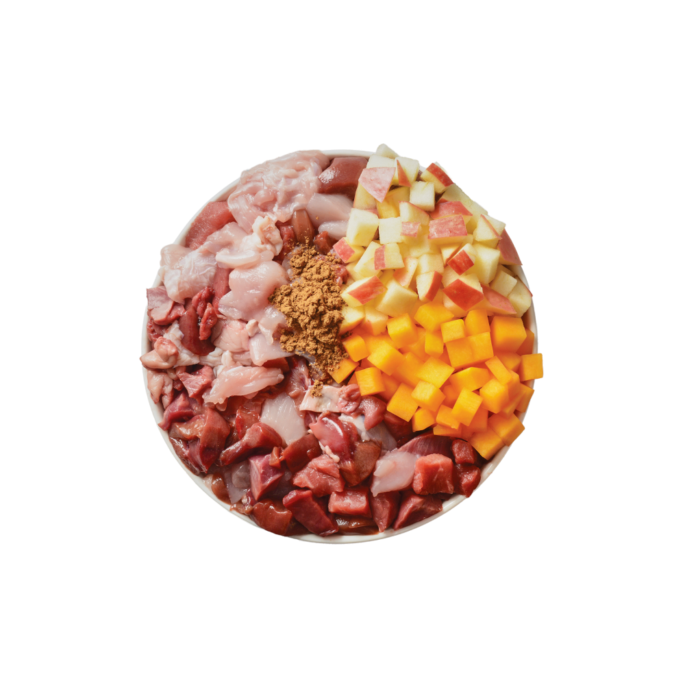 Round dish with raw meats, cheese, and spices on a white background